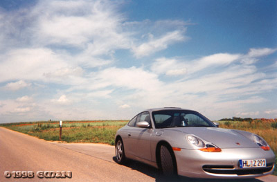 The sky is blue, the grass is green, the Porsche is silver...